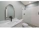 Stylish bathroom featuring a decorative mirror, marble vanity, and walk-in shower at 120 Lu Tom Ln, Wendell, NC 27591