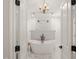 Elegant bathroom featuring a freestanding tub, dual rain shower, and marble flooring visible through open doorway at 120 Lu Tom Ln, Wendell, NC 27591