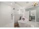 Bright, spa-like bathroom with freestanding tub, rain shower, white tiling, and marble floors provides a relaxing retreat at 120 Lu Tom Ln, Wendell, NC 27591
