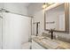 Neutral toned bathroom with a shower and granite countertop with a white sink and framed mirror at 120 Lu Tom Ln, Wendell, NC 27591