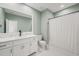This bathroom features a white vanity, marble countertop, and classic patterned tile flooring at 120 Lu Tom Ln, Wendell, NC 27591