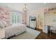 Bright bedroom featuring whimsical floral wallpaper, shuttered windows, and a built-in desk at 120 Lu Tom Ln, Wendell, NC 27591