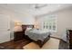 Bright bedroom featuring a dark wood floor, two dressers, ceiling fan, and natural lighting at 120 Lu Tom Ln, Wendell, NC 27591