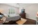 Bedroom with dark wood floors, dresser, natural light from the window and ceiling fan at 120 Lu Tom Ln, Wendell, NC 27591
