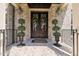 Close-up of front entrance featuring double doors decorated with holiday wreaths, and brick stairs at 120 Lu Tom Ln, Wendell, NC 27591