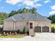 Rear exterior showcasing brick detail, two-car garage, and an American flag waving gently at 120 Lu Tom Ln, Wendell, NC 27591