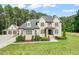 Stately brick home featuring manicured landscaping, a welcoming entrance, and attached garage at 120 Lu Tom Ln, Wendell, NC 27591