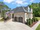 Exterior view highlighting the home's architecture, drive, and beautifully landscaped surroundings at 120 Lu Tom Ln, Wendell, NC 27591