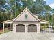 Detached two-car garage with covered parking area and surrounded by lush greenery at 120 Lu Tom Ln, Wendell, NC 27591