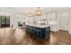 Spacious kitchen featuring a large island with seating, pendant lights, and white cabinetry at 120 Lu Tom Ln, Wendell, NC 27591