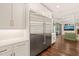 Bright kitchen features a large stainless steel refrigerator and plenty of white cabinets at 120 Lu Tom Ln, Wendell, NC 27591
