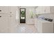 Well-lit laundry room features modern washer and dryer, stylish tile flooring, and ample cabinet space at 120 Lu Tom Ln, Wendell, NC 27591