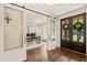 View from the doorway to the home office with hardwood floors, desk, and natural light at 120 Lu Tom Ln, Wendell, NC 27591