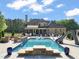 Backyard pool featuring a slide, stone accents, and plenty of lounge seating at 120 Lu Tom Ln, Wendell, NC 27591
