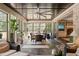 Spacious sunroom with a dining table, lounge seating, and large windows with outdoor views at 120 Lu Tom Ln, Wendell, NC 27591