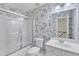 Bathroom with shower and tub featuring white tile surround and patterned wall paper at 1201 Red Beech Ct, Raleigh, NC 27614