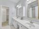 Bright bathroom with double sinks, white cabinets, gold hardware and trim, and ample counter space at 1201 Red Beech Ct, Raleigh, NC 27614