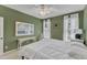 This bedroom features a ceiling fan, white trim, and a decorative painting adding character to the space at 1201 Red Beech Ct, Raleigh, NC 27614