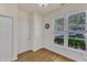 The breakfast nook boasts hardwood flooring and an abundance of natural light from a large window at 1201 Red Beech Ct, Raleigh, NC 27614