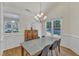 Formal dining room featuring a modern chandelier, a dining table, and plenty of natural light at 1201 Red Beech Ct, Raleigh, NC 27614