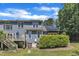 Backyard view showcasing the two-story home, deck, green space, and solar panels at 1201 Red Beech Ct, Raleigh, NC 27614