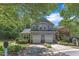 Two-story home with an attached two-car garage, surrounded by lush greenery and mature trees at 1201 Red Beech Ct, Raleigh, NC 27614