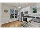 Bright kitchen features granite countertops, white cabinets, stainless steel appliances, and hardwood floors at 1201 Red Beech Ct, Raleigh, NC 27614