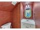 Unique powder room with textured walls, white vanity, updated fixtures, and octagon mirror at 1201 Red Beech Ct, Raleigh, NC 27614