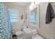 Cozy bathroom with a pedestal sink, a patterned shower curtain, and a patterned black-and-white floor at 1209 Eva St, Durham, NC 27703