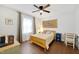 Cozy bedroom featuring hardwood floors, a ceiling fan, and warm natural lighting at 1209 Eva St, Durham, NC 27703
