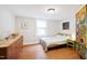 Bedroom featuring hardwood floors, bright natural lighting, and eclectic decor at 1209 Eva St, Durham, NC 27703