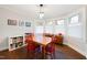 Bright dining room featuring hardwood floors, a modern light fixture, and views from the bay window at 1209 Eva St, Durham, NC 27703