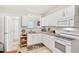 Bright kitchen with white cabinets, granite countertops, and modern appliances at 1209 Eva St, Durham, NC 27703