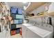 Well-organized laundry room with shelving, storage containers, and a convenient washer and dryer at 1209 Eva St, Durham, NC 27703