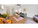 Inviting living room featuring hardwood floors, a large built-in bookshelf, and ample natural light at 1209 Eva St, Durham, NC 27703