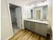 Bright bathroom featuring double sinks, granite counters and walk-in closet at 121 Earnest Way, Kenly, NC 27542