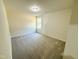 Bright bedroom features plush carpeting, a window for natural light, and neutral walls at 121 Earnest Way, Kenly, NC 27542