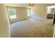 Bedroom featuring plush carpeting, a ceiling fan, and natural light from two windows at 121 Earnest Way, Kenly, NC 27542