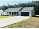Attractive single-story home featuring a spacious driveway and attached two-car garage at 121 Earnest Way, Kenly, NC 27542