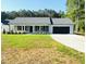 Charming single-story home boasts a well-manicured lawn and an attached two-car garage at 121 Earnest Way, Kenly, NC 27542
