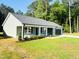Inviting single-story home boasts fresh landscaping, a covered porch, and an attached garage at 121 Earnest Way, Kenly, NC 27542