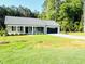 Traditional single-story home featuring a well-kept front lawn and lovely landscaping at 121 Earnest Way, Kenly, NC 27542