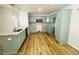 Bright kitchen features granite countertops, wood-look flooring, and sleek, modern appliances at 121 Earnest Way, Kenly, NC 27542
