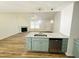 Open-concept kitchen with modern countertops, wood floors, and view into the living area at 121 Earnest Way, Kenly, NC 27542