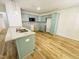 Bright kitchen features granite countertops, wood-look flooring, and sleek, modern appliances at 121 Earnest Way, Kenly, NC 27542