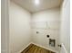 Efficient laundry room with ample space for laundry appliances and shelving for storage at 121 Earnest Way, Kenly, NC 27542