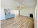 Spacious living area showcases a fireplace, wood floors, and seamlessly connected kitchen area at 121 Earnest Way, Kenly, NC 27542