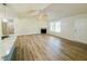 Bright living area with wood floors, a cozy fireplace, and open layout to the kitchen at 121 Earnest Way, Kenly, NC 27542