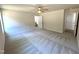 Spacious primary bedroom with plush carpeting, ceiling fan and ensuite bathroom at 121 Earnest Way, Kenly, NC 27542