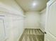 Walk-in closet providing ample storage with multiple wire racks and neutral carpet at 121 Earnest Way, Kenly, NC 27542